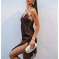 Woman in elegant brown lace slip dress with white clutch, perfect for evening fashion