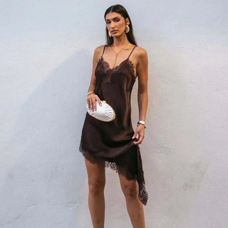 Woman in elegant brown lace slip dress with white clutch, fashion style