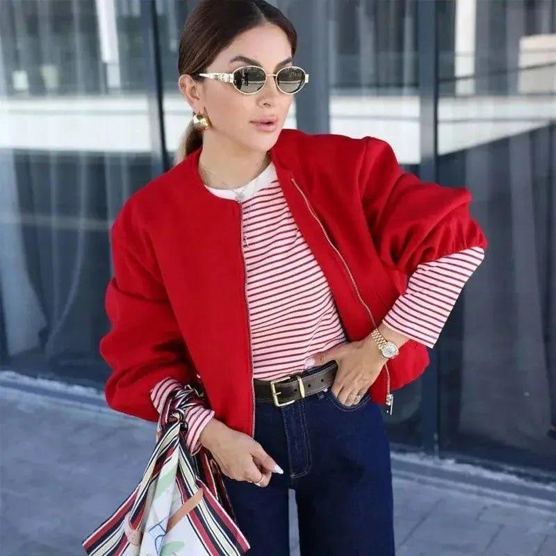 Woman in red bomber jacket, striped top, and jeans – stylish streetwear fashion