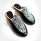 Black and white patterned women's slip-on mules with geometric design, stylish fashion footwear