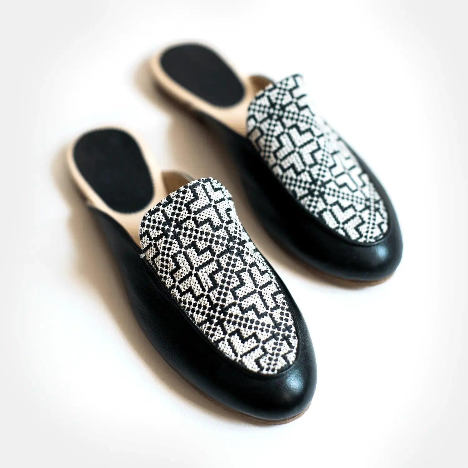 Black and white patterned women's slip-on mules with geometric design, stylish fashion footwear