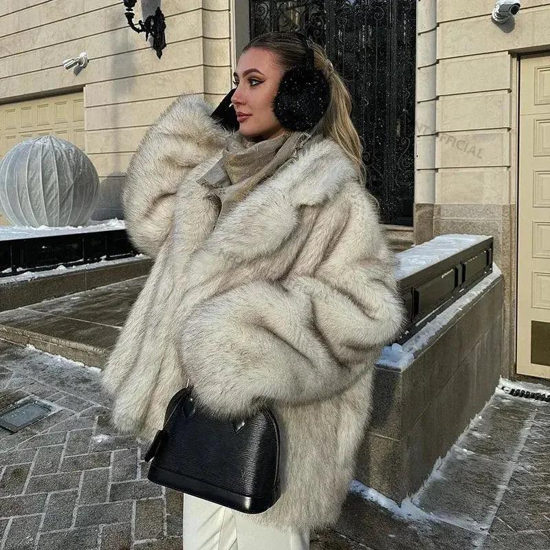 Woman in luxury faux fur coat, winter fashion, black earmuffs, stylish handbag, snowy outdoor setting