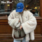 Woman in fluffy white faux fur coat, blue AVATA cap, holding designer bag, street fashion style