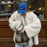 Woman in fluffy white faux fur coat, blue AVATA cap, holding designer bag, street fashion style
