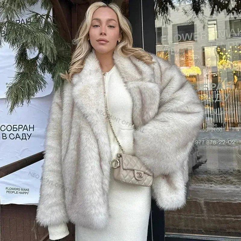 Woman in chic white faux fur coat and matching dress, carrying quilted handbag, stylish winter fashion