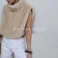 Cream faux fur sleeveless vest with high neck, styled with white jeans for women's fashion