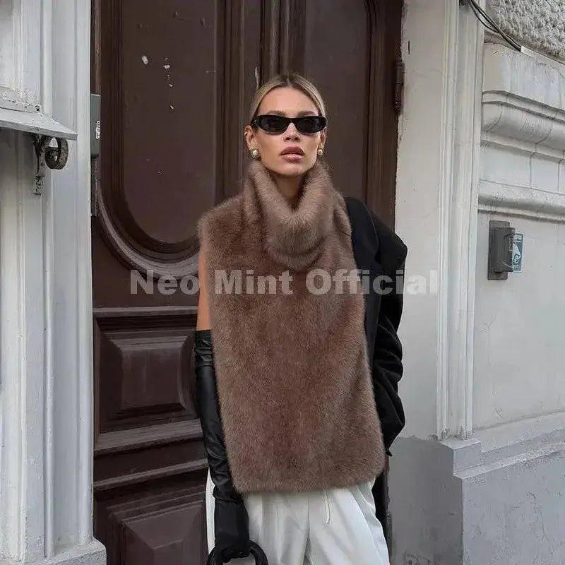 Woman in chic brown faux fur vest, black sunglasses, and leather gloves for stylish streetwear fashion