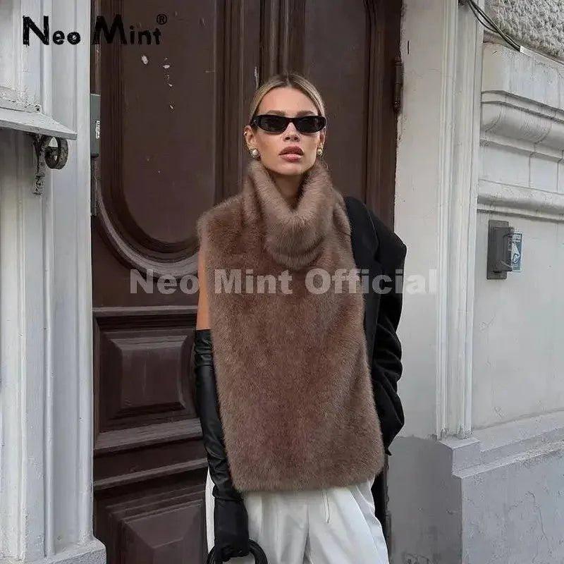 Woman wearing chic brown faux fur vest, black gloves, and sunglasses for stylish street fashion