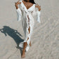 White ruffled beach cover-up dress with deep V-neck and side slits, perfect for summer fashion