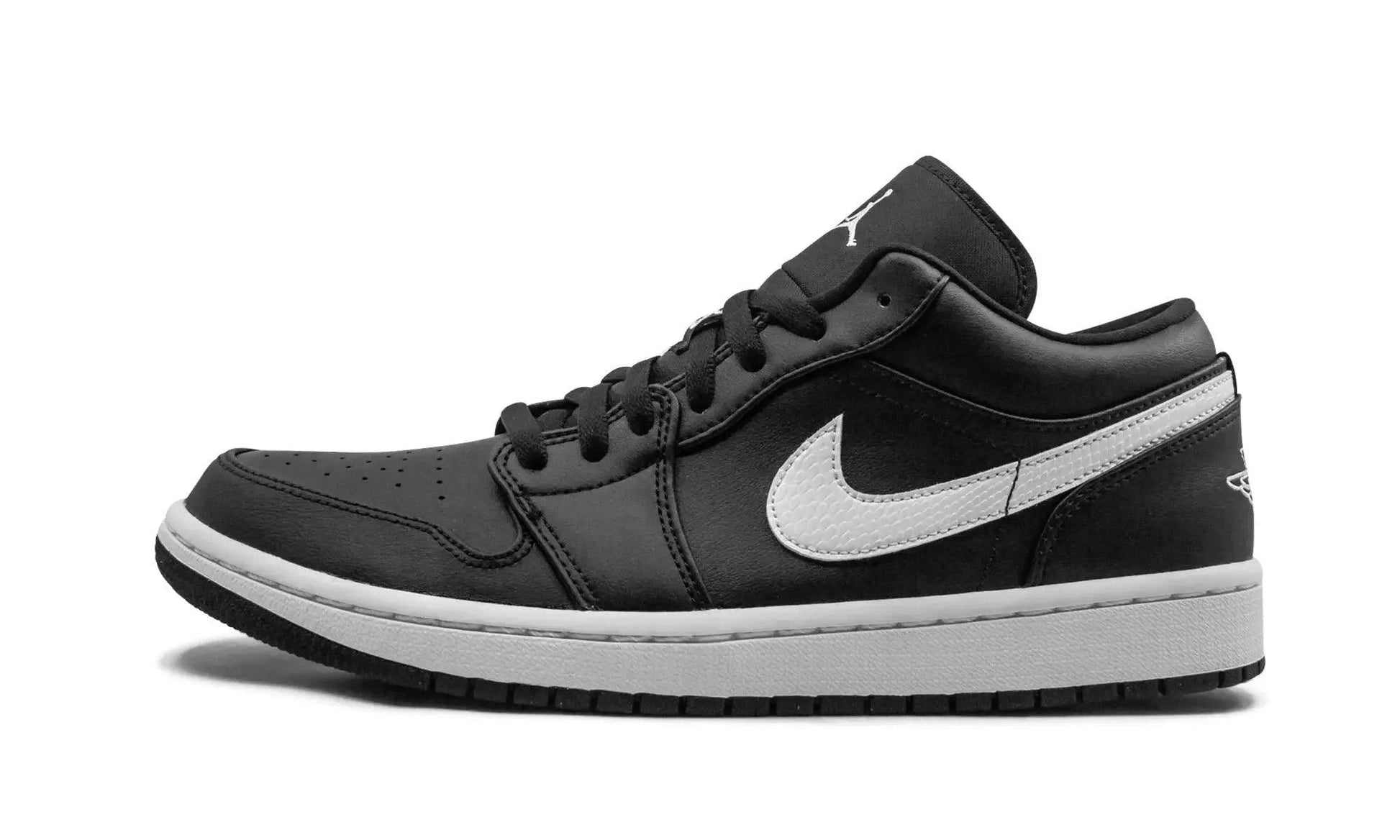 Black and white women's Air Jordan 1 low sneaker with Nike swoosh, stylish fashion footwear