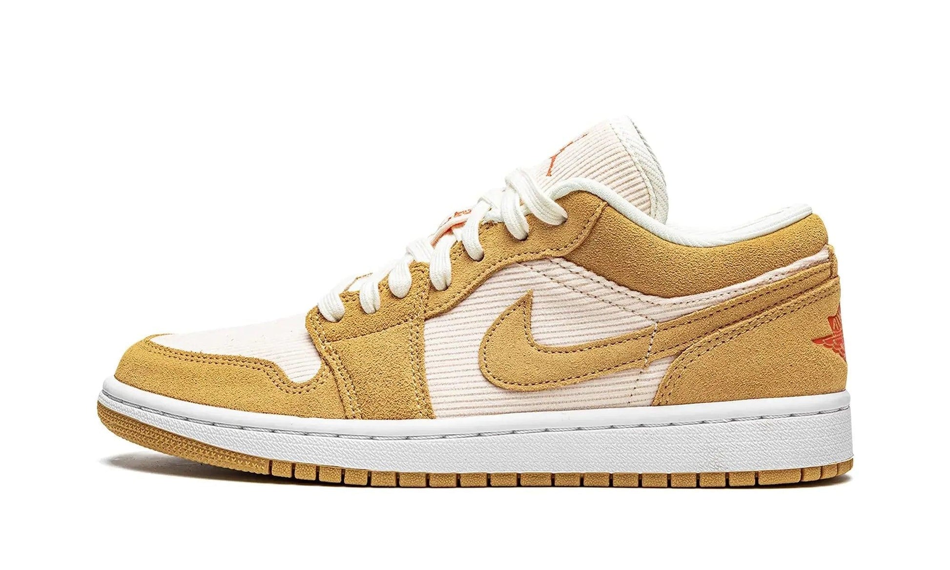 Women's tan and white low-top sneaker with corduroy texture and Nike swoosh