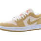 Beige and white low-top sneaker with orange Jumpman logo, ideal for women's fashion and casual wear