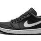 Black and white women's low-top sneaker with iconic swoosh, perfect for casual fashion and streetwear styles.