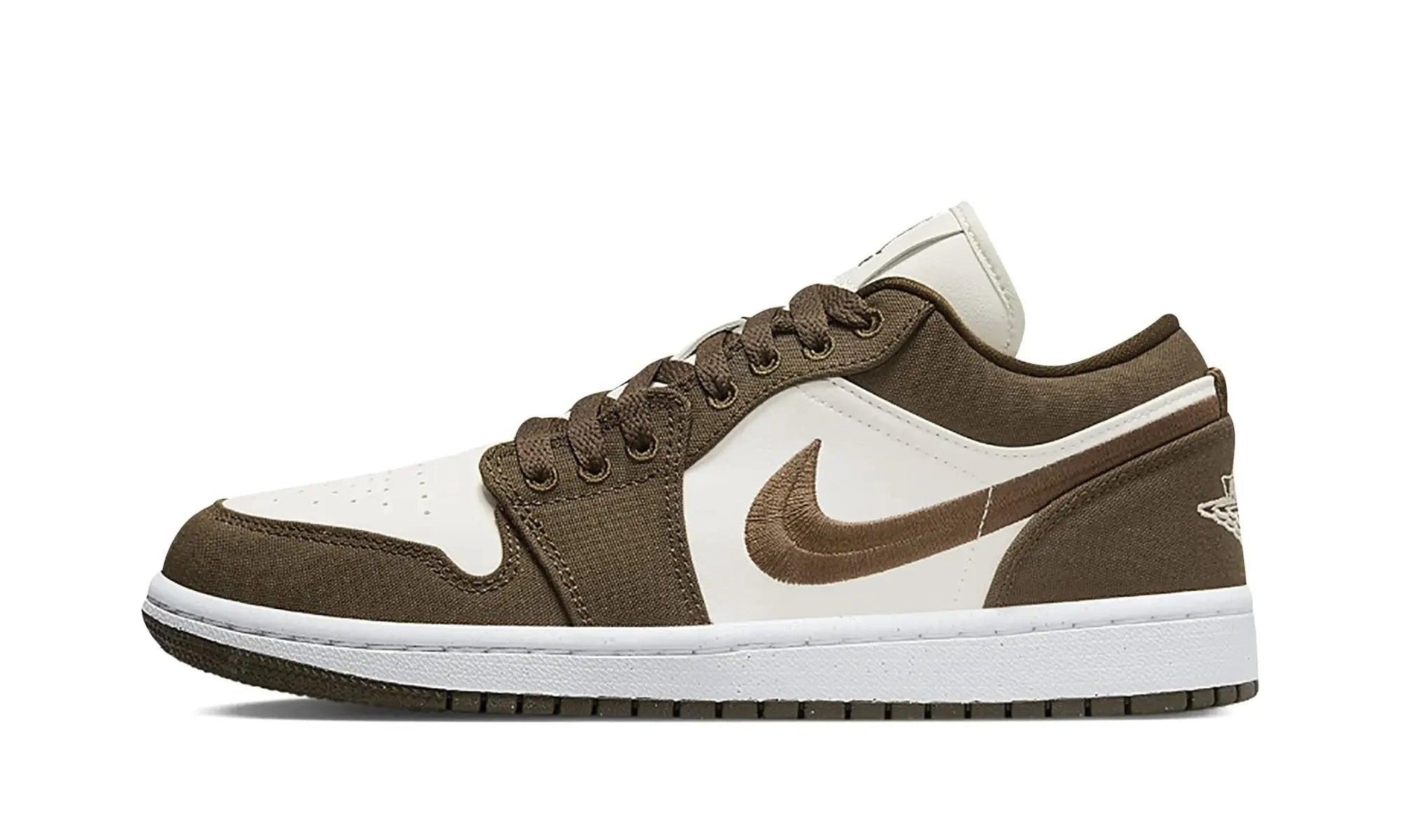 Brown and white low-top sneaker with Nike swoosh, casual fashion footwear