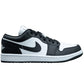 Black and white low-top sneaker with iconic swoosh, perfect for women's fashion and streetwear style.