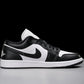 Black and white low-top sneaker with Nike swoosh and Jumpman logo, stylish women's fashion footwear