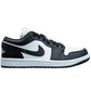 Black and white low-top sneaker with Nike swoosh, perfect for women's fashion and streetwear style.