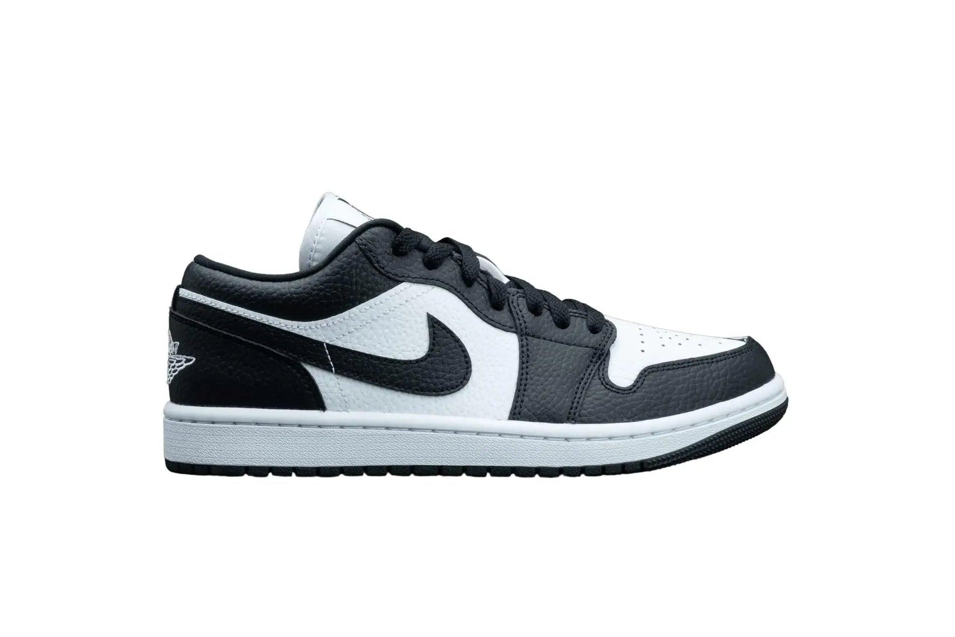 Black and white low-top sneaker with Nike swoosh, perfect for women's fashion and streetwear style.