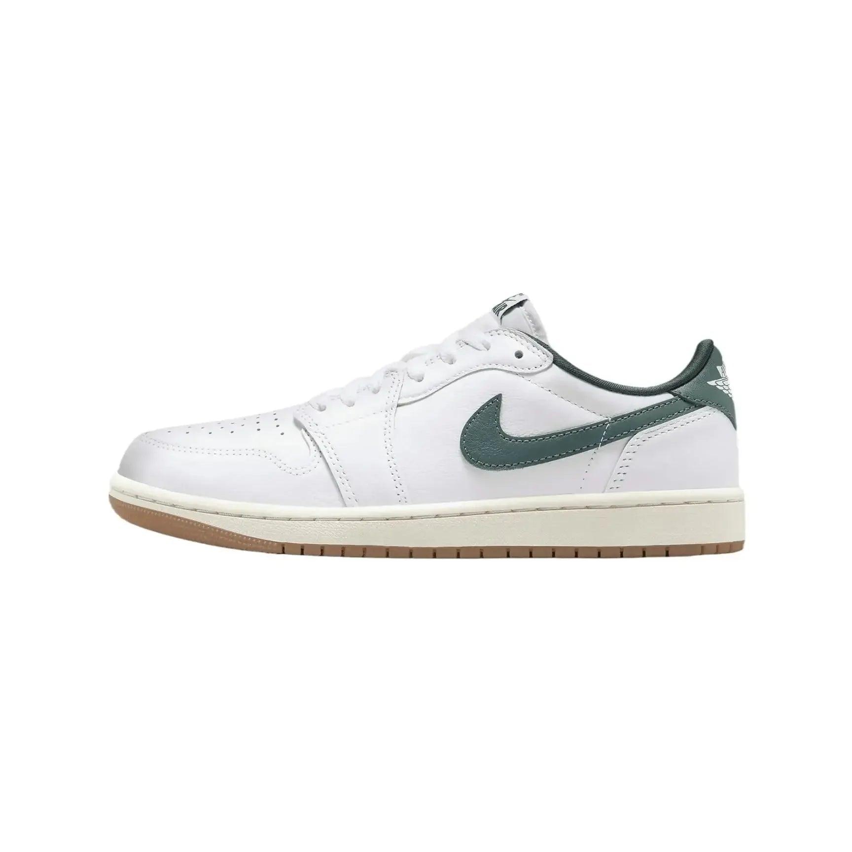 White low-top sneaker with green swoosh and gum sole, stylish women's fashion footwear