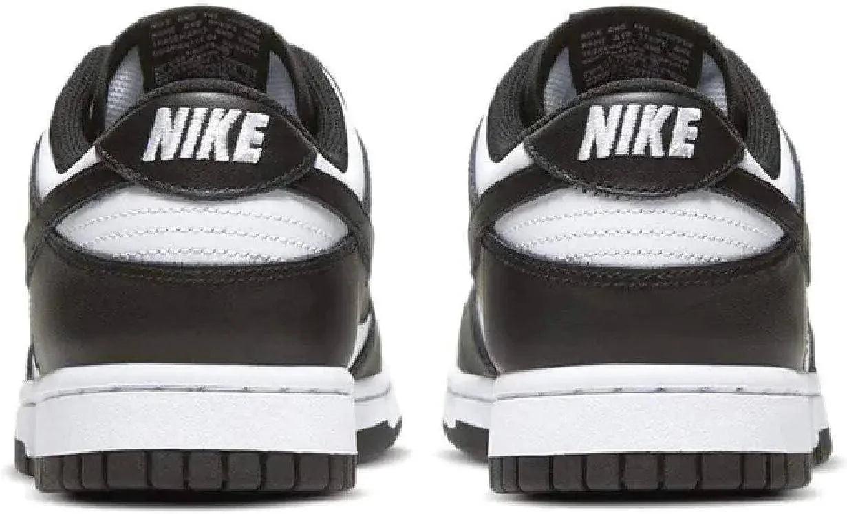 Black and white Nike sneakers with bold logo, stylish women's fashion footwear