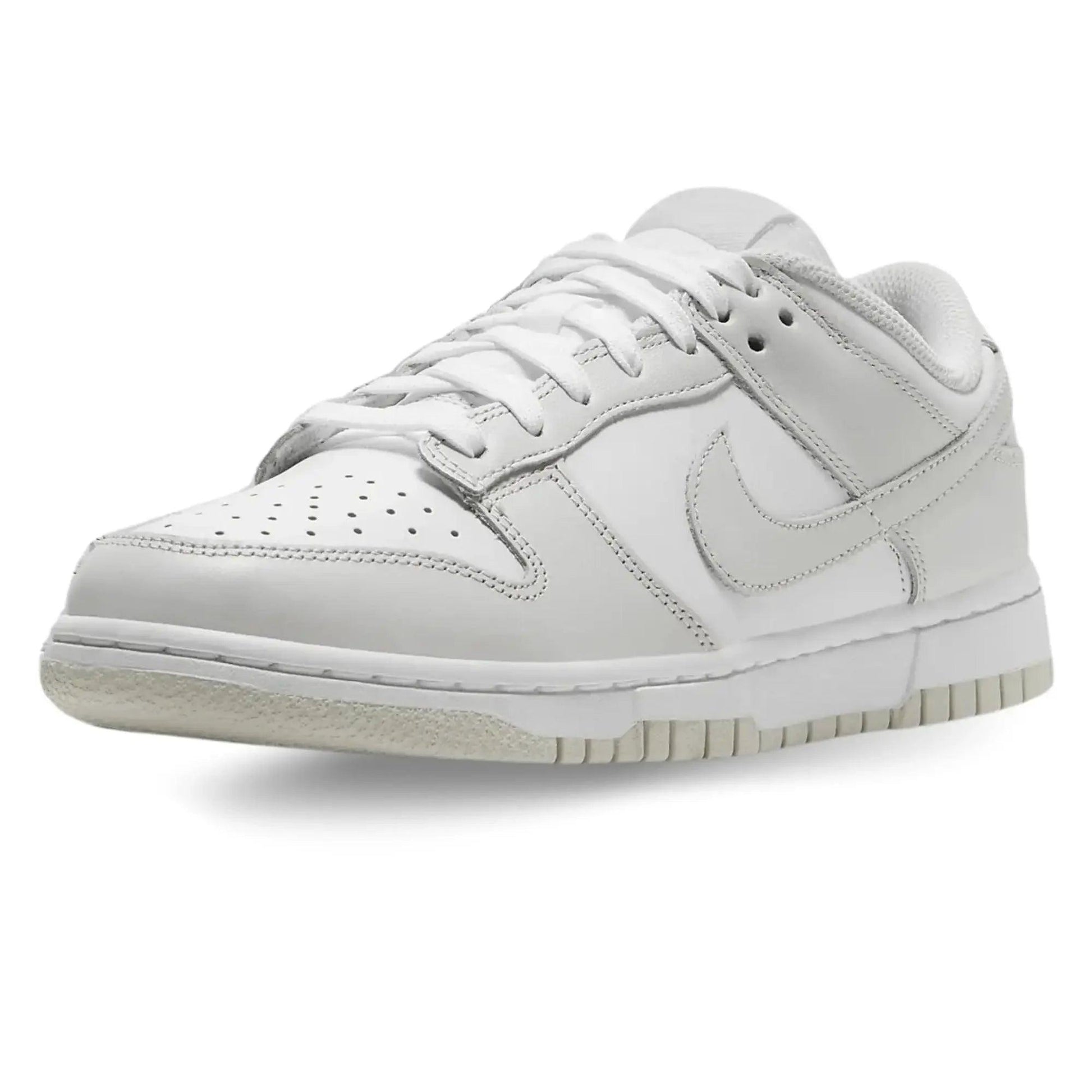 White Nike Dunk Low sneaker with clean design, perforated toe, and classic swoosh for women's fashion