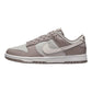 Gray Nike Dunk Low sneaker with white swoosh, perfect for women's fashion and casual wear