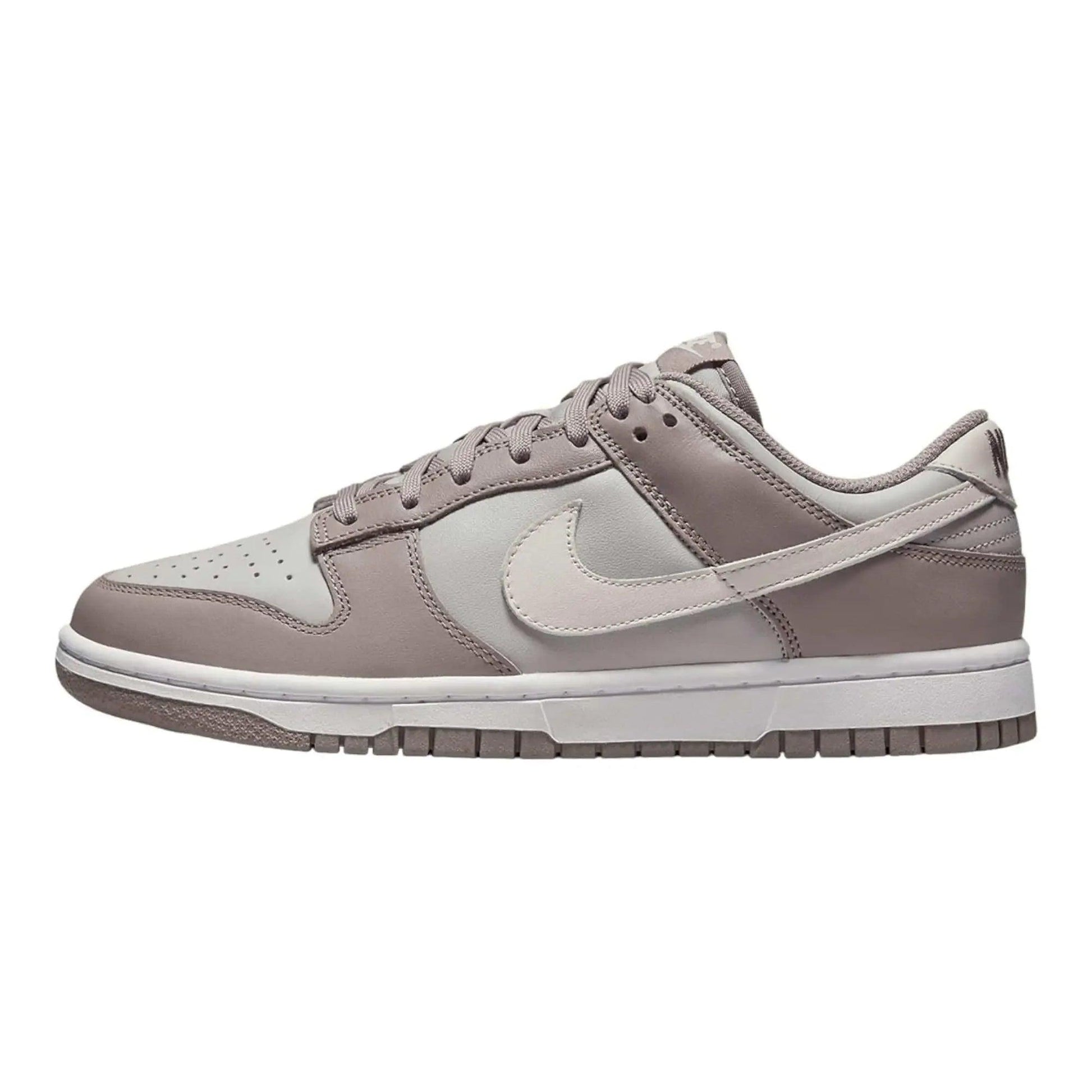 Gray Nike Dunk Low sneaker with white swoosh, perfect for women's fashion and casual wear