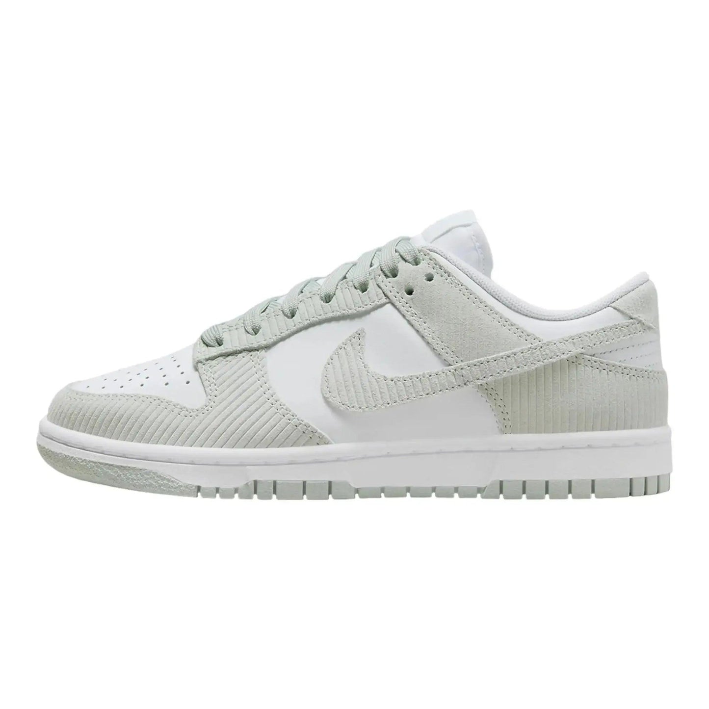 White and light green Nike Dunk Low sneaker with textured panels and classic design