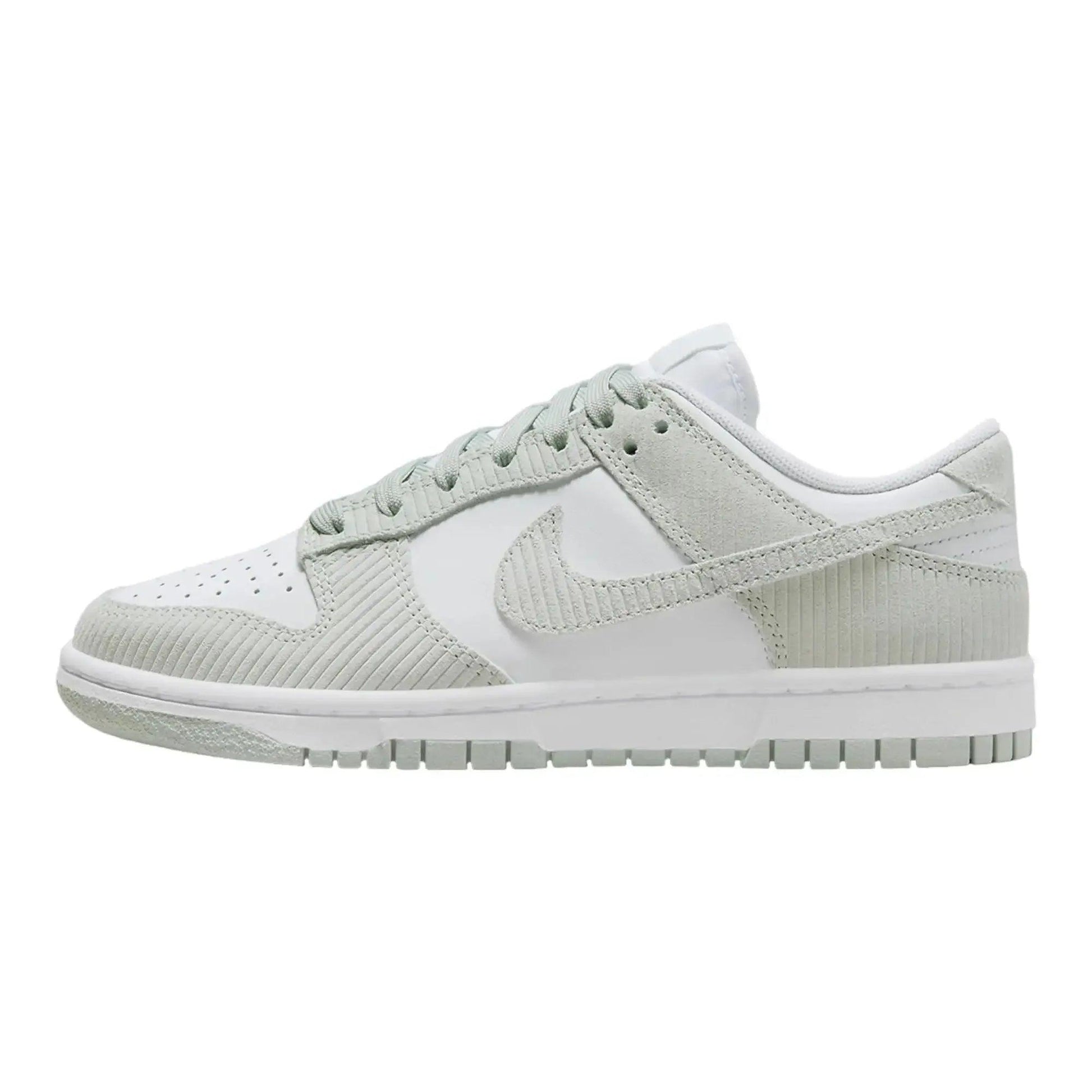 White and light green Nike Dunk Low sneaker with textured panels and classic design
