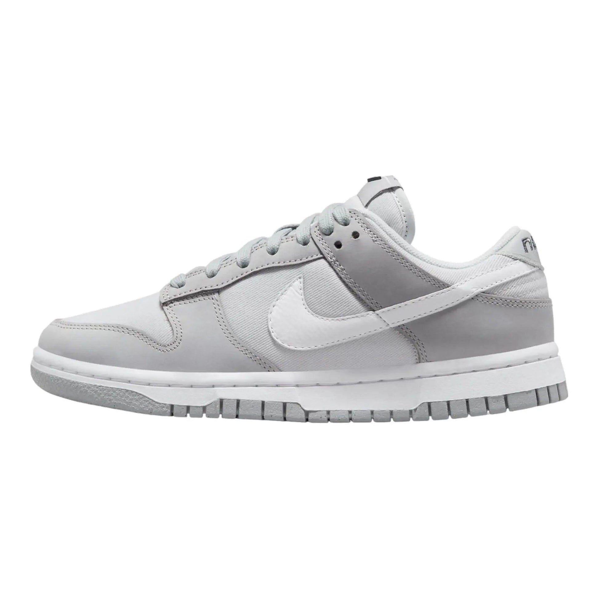 Gray Nike Dunk Low sneaker with white swoosh, ideal for women's fashion and casual wear