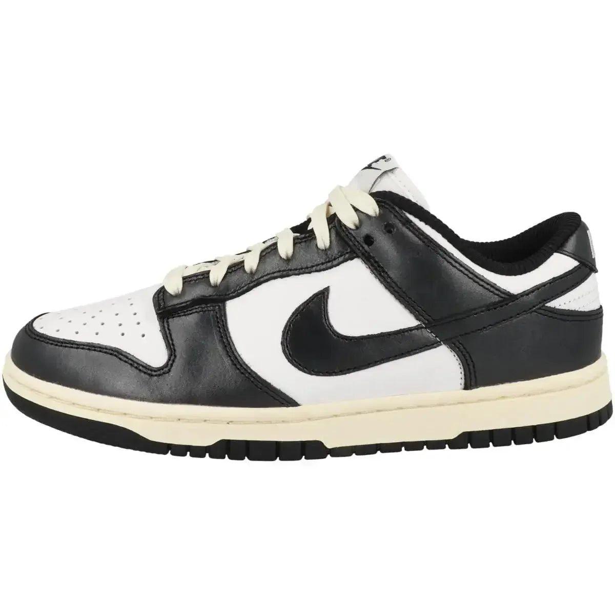 Black and white Nike Dunk Low sneaker with cream sole, classic low-top design for women's fashion
