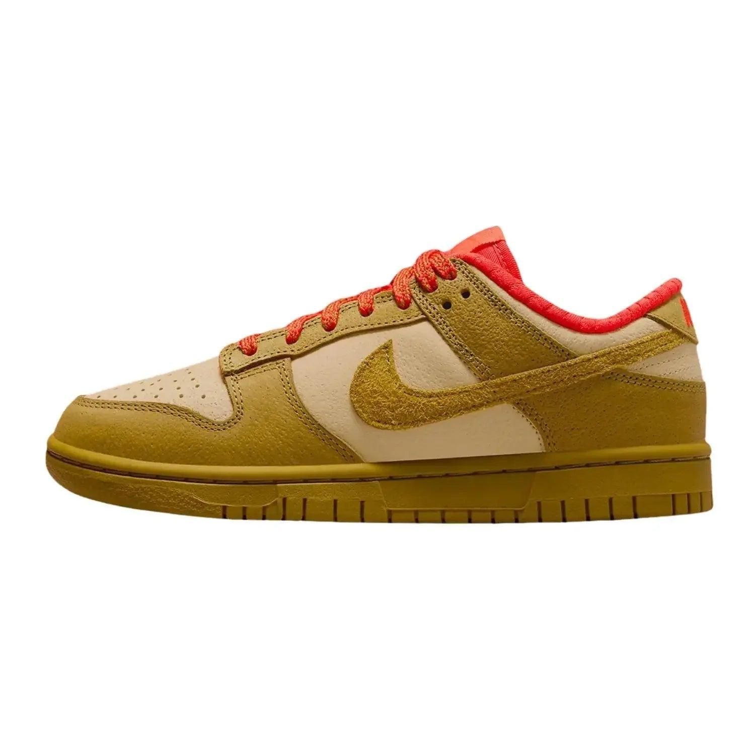 Tan and cream Nike Dunk Low sneaker with vibrant orange laces and Swoosh, stylish women's fashion footwear