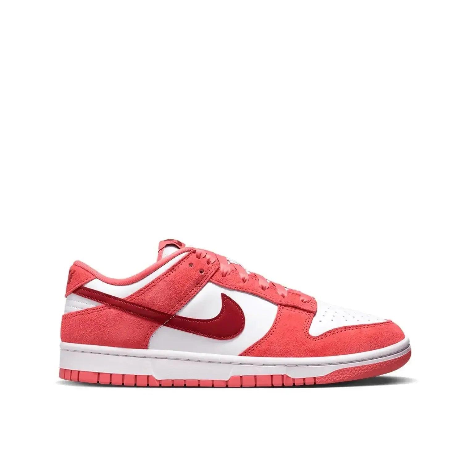 Red and white Nike Dunk Low sneaker with suede texture, ideal for women's fashion and casual wear