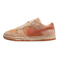 Women's Nike Dunk Low sneaker in peach and coral suede, stylish casual footwear for fashion lovers