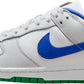 White Nike Dunk Low sneaker with royal blue swoosh and green sole, women's fashion footwear