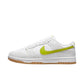 White Nike Dunk Low sneaker with neon yellow Swoosh and gum sole, women's fashion footwear