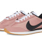 Pink Nike Cortez sneakers with black swoosh, white laces, and gum sole for women's fashion