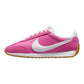 Vibrant pink women's sneaker with white swoosh, gum sole, and retro design for casual fashion