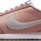 Pink Nike Cortez women's sneaker with white laces and gum sole, retro running shoe style