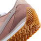 Pink Nike sneaker with gum sole and textured tread, women's fashion footwear