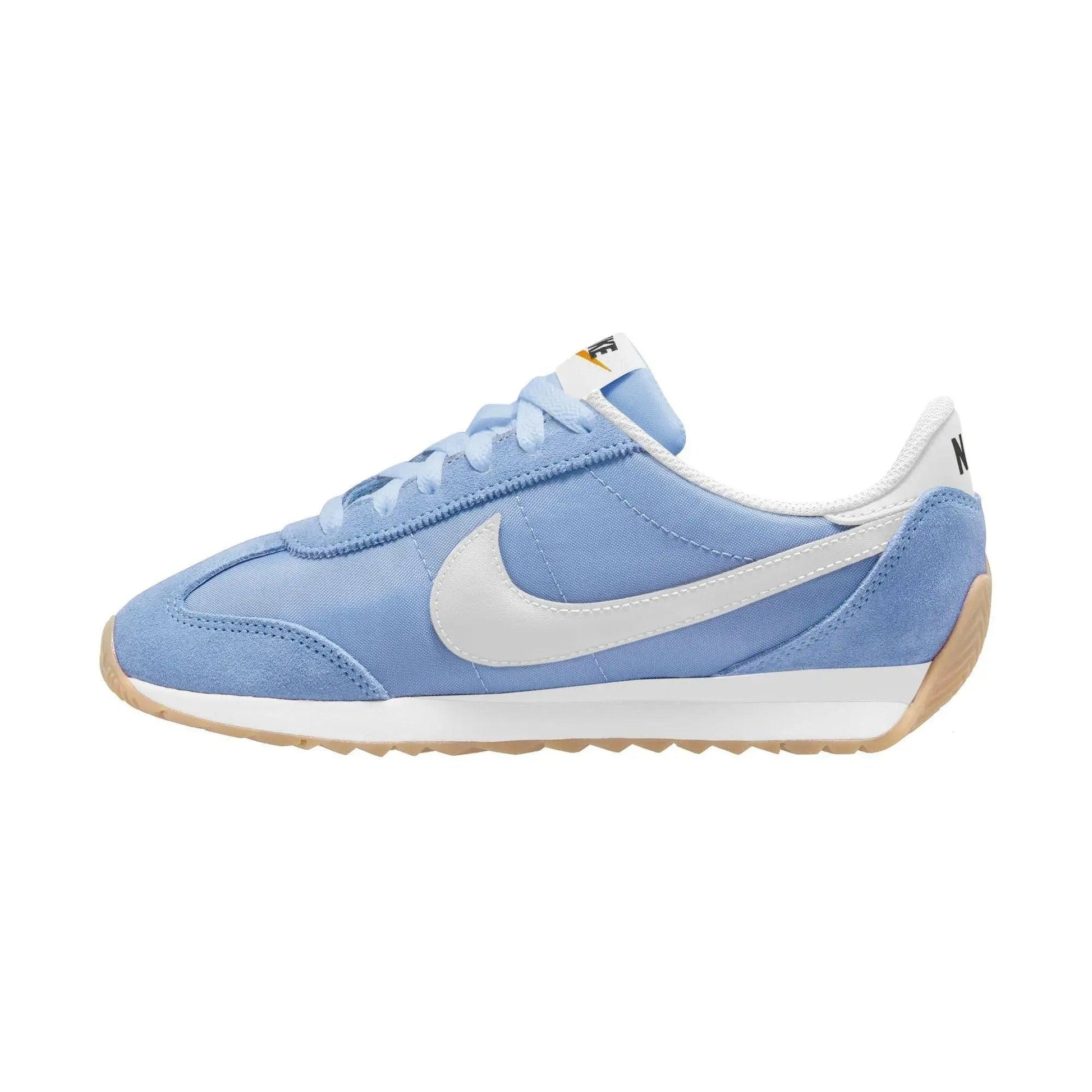 Light blue Nike sneaker with white swoosh, gum sole, and retro design for women's fashion