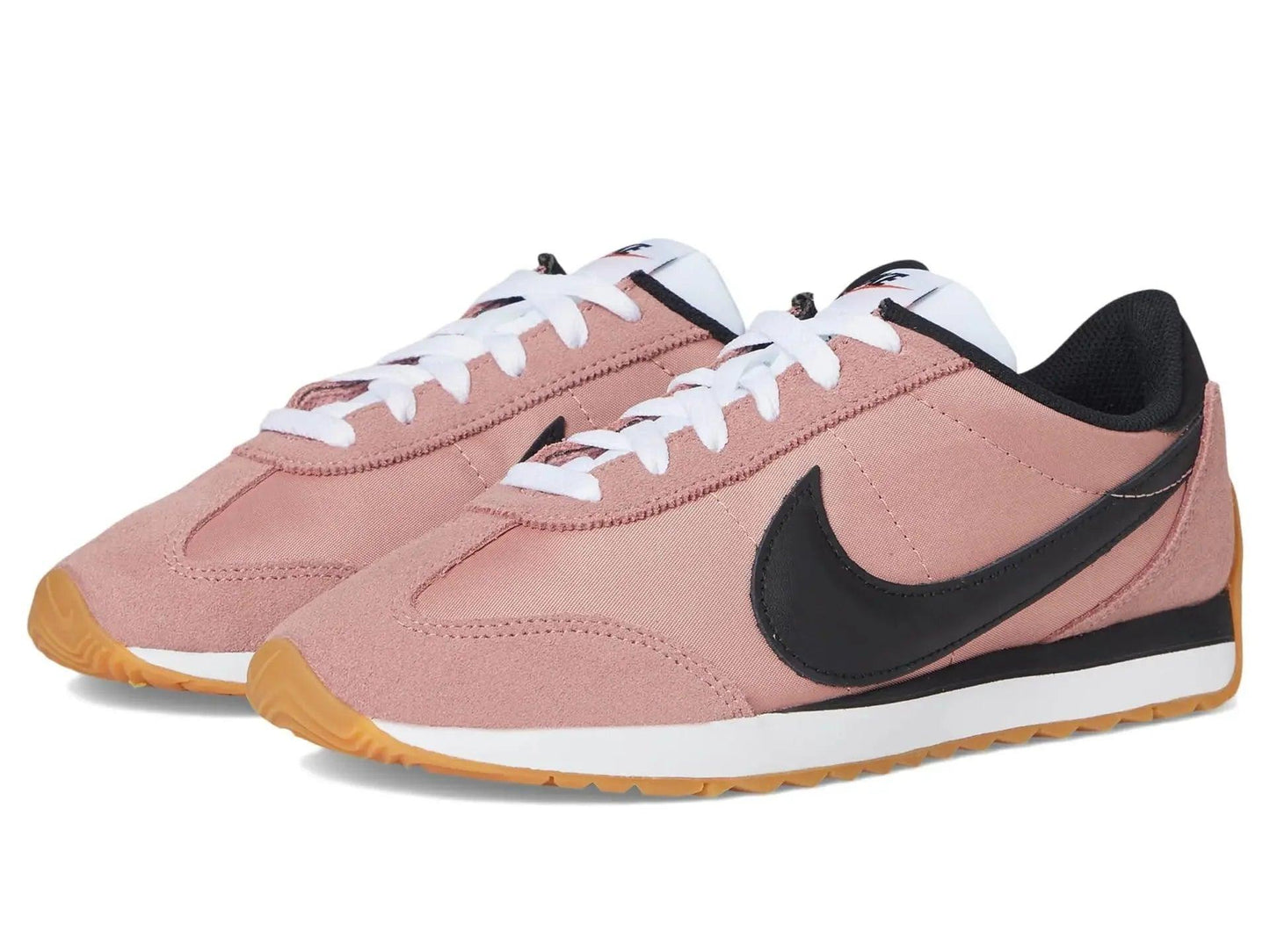 Pink women's Nike sneakers with black swoosh, white laces, and gum sole for casual fashion