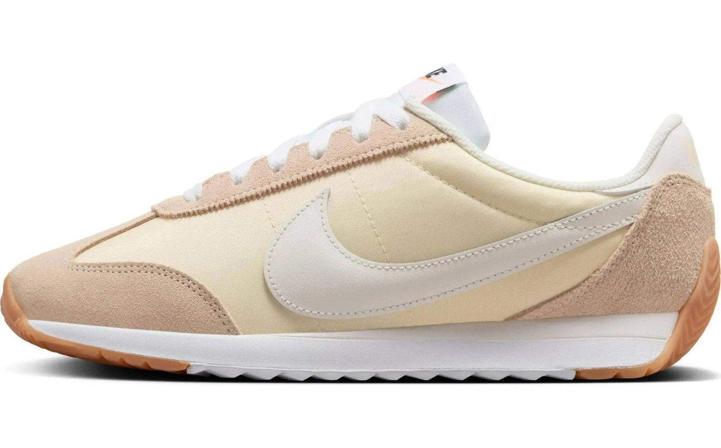Beige and cream Nike sneaker with white swoosh, suede accents, and gum sole for women's fashion
