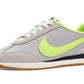 Gray and neon green women's retro running sneaker with gum sole, perfect for casual fashion and everyday wear.