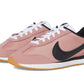 Pink Nike Cortez sneakers with black swoosh, white laces, and gum sole for women's fashion