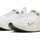 White Nike running shoes with black soles and silver swoosh, lightweight athletic footwear for women