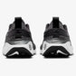 Black and white Nike running shoes with floral design, rear view