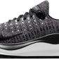Nike React X running shoe with black and white knit upper, cushioned sole, and swoosh logo for women's fashion