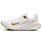 White women's running shoe with gold swoosh, breathable knit upper, and cushioned sole for comfort and style