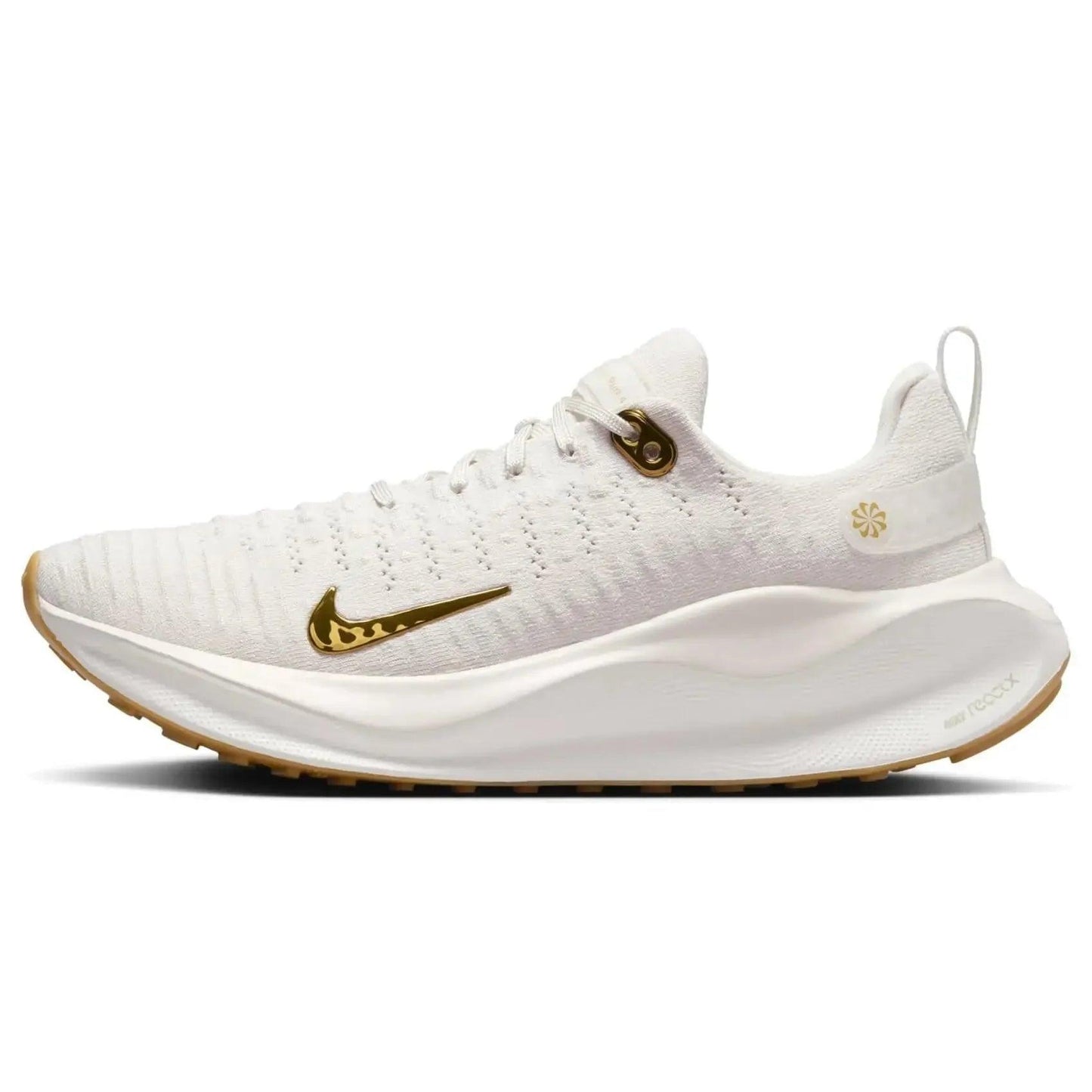 White women's running shoe with gold swoosh, breathable knit upper, and cushioned sole for comfort and style